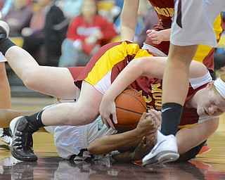 Jeff Lange | The Vindicator  Mooney's Maggie Monahan topples to the floor as she fights for possession of the ball with Boardman's Doricia Robinson in the second half of Saturday's basketball game in Boardman.