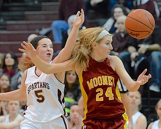 Jeff Lange | The Vindicator  Boardman's Marisa Hanna (5) smacks the ball away from Mooney's Kelly Williams (24) in the first period of their game in Boardman, Saturday night.