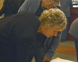 Katie Rickman | The Vindicator.Linda Vasquez signs well-wishes to the Traficant family as her husband Sam looks over her shoulder prior to the tribute for Traficant at the Deyore Performing Arts Center on Sunday, Nov. 2014 Youngstown, Ohio.