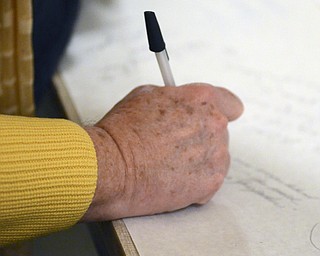 Katie Rickman | The Vindicator.A woman writes a message to the Traficant family after the tribute for Traficant at the Deyore Performing Arts Center on Sunday, Nov. 2014 Youngstown, Ohio.