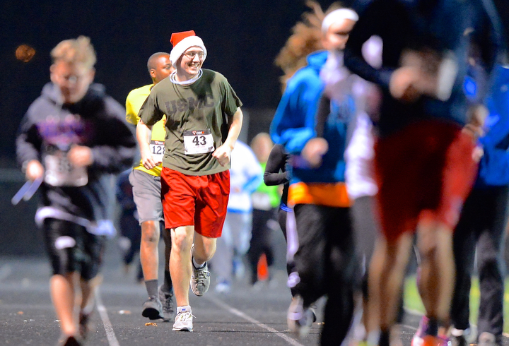 Jeff Lange | The Vindicator  Runner Matt Mosier (43) smiles as he trails behind the pack while running in the over 6 minute mile race, Sunday evening at Austintown High School.
