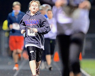 Jeff Lange | The Vindicator  Austintown's Graham Bosley (59) looks on at the runner ahead of him as he nears the finish line of the mile race, Sunday evening at Austintown High School during the 1st ALS Polar Run.