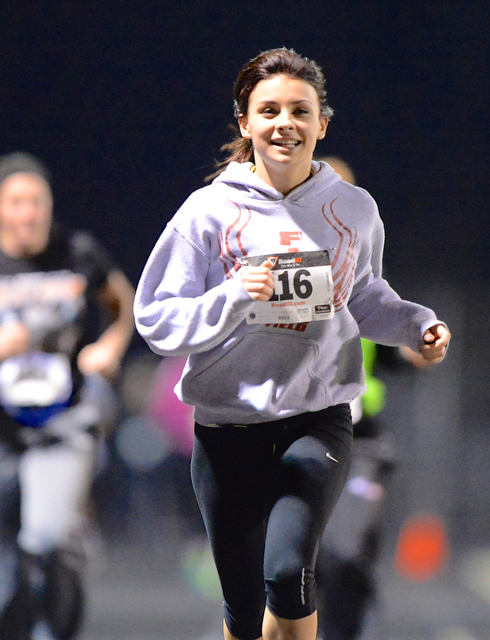 Jeff Lange | The Vindicator  Austintown junior Kelsie Diefenderfer smiles as she leads a pack of runners to the finish line of the 1 mile race during the 1st annual Polar Run at Austintown High School.