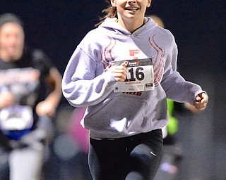 Jeff Lange | The Vindicator  Austintown junior Kelsie Diefenderfer smiles as she leads a pack of runners to the finish line of the 1 mile race during the 1st annual Polar Run at Austintown High School.