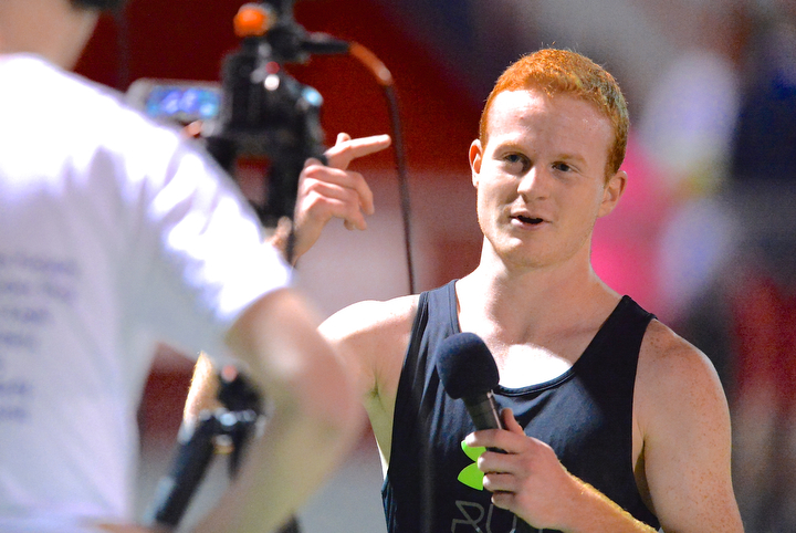 Jeff Lange | The Vindicator  Josh Potkanowicz (right) speaks to the camera during a post-race interview. Potkanowicz captured first place in the under 6 minute mile race, Sunday during the Polar Run at Austintown Fitch High School.