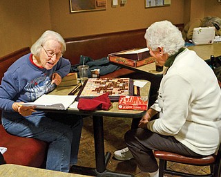 Isabel Huber, left, and Elaine Monteleone play Scrabble at the Poland Library. The friends have been playing Scrabble together for more than four years and enjoy each other’s company.