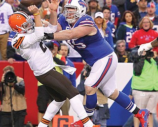 Browns rookie quarterback Johnny Manziel loses the ball under pressure from Bills defensive tackle Kyle Williams in the second half of their game Sunday at Ralph Wilson Stadium in Orchard Park, N.Y. Manziel, who replaced Brian Hoyer early in the fourth quarter, scored a touchdown, but it wasn’t enough as Cleveland fell 26-10 to Buff alo.