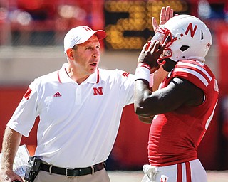 Nebraska head coach Bo Pelini talks to quarterback Tommy Armstrong Jr. during a game in Lincoln, Neb. Pelini, a Cardinal Mooney graduate, was dismissed as Cornhuskers coach Sunday after a seven-year stint.