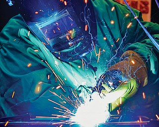 Esther Thomas of Struthers welds steel. She is one of four women who take welding and machinery classes at MCCTC.