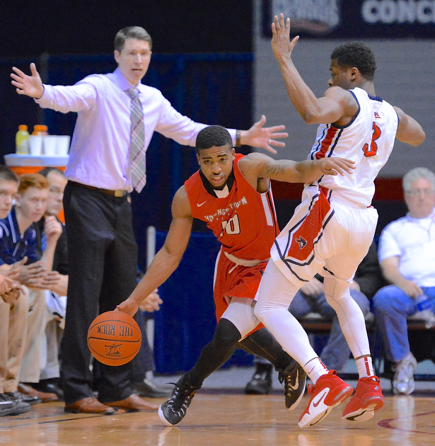 Jeff Lange | The Vindicator  Marcus Keene of Youngstown (10) takes the ball past Robert Morris' Kavon Stewart (3) as Colonials head coach Andrew Toole reacts to the play from behind, Tuesday night in the second half of their matchup in Moon, PA.