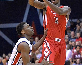 Jeff Lange | The Vindicator  Youngstown's DJ Cole (11) hops to make a pass over Colonials' Kavon Stewart in the second half of Tuesday's matchup in Moon, PA.