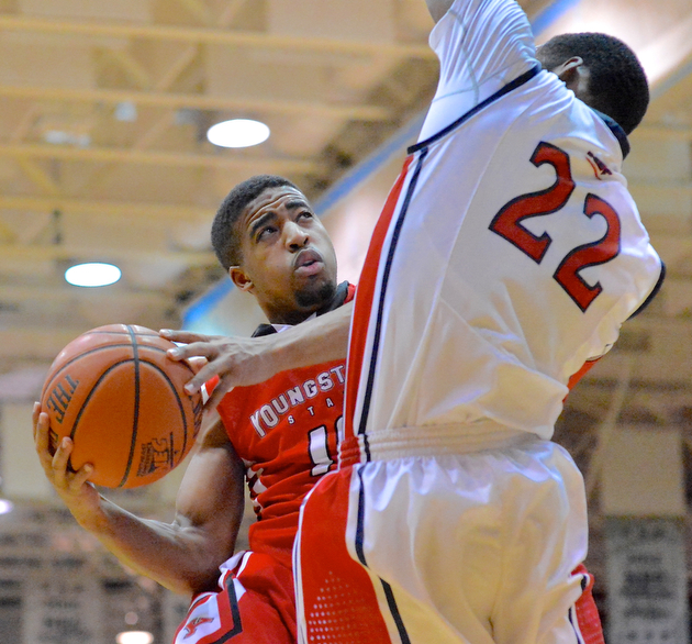 Jeff Lange | The Vindicator  Youngstown's Marcus Keene (left) is fouled on his way to the basket by Colonials' Lucky Jones (22) in the second half of Tuesday's game in Moon, PA.