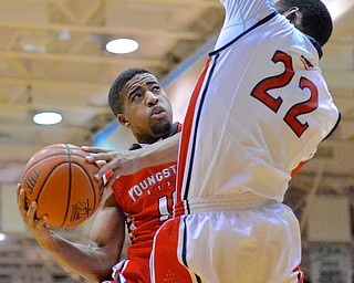 Jeff Lange | The Vindicator  Youngstown's Marcus Keene (left) is fouled on his way to the basket by Colonials' Lucky Jones (22) in the second half of Tuesday's game in Moon, PA.