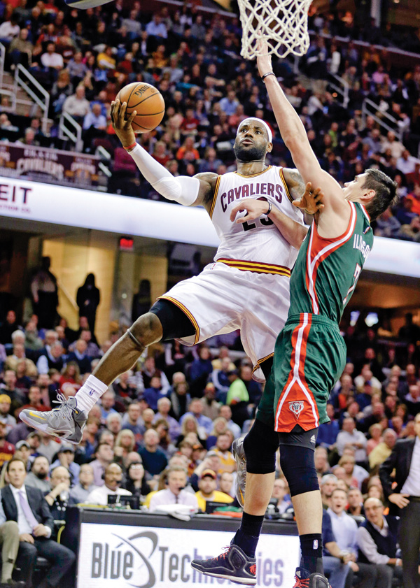 The Cleveland Cavaliers’ LeBron James (23) drives to the basket against the Milwaukee Bucks’ Ersan Ilyasova (7)
during the second quarter of a game Tuesday in Cleveland.