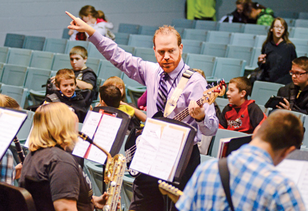 Josh Hawkins, band director for Struthers schools, directs the middle school jazz band during practice Tuesday morning in the Struthers Middle School auditorium. The students are preparing for their second concert as a jazz band.