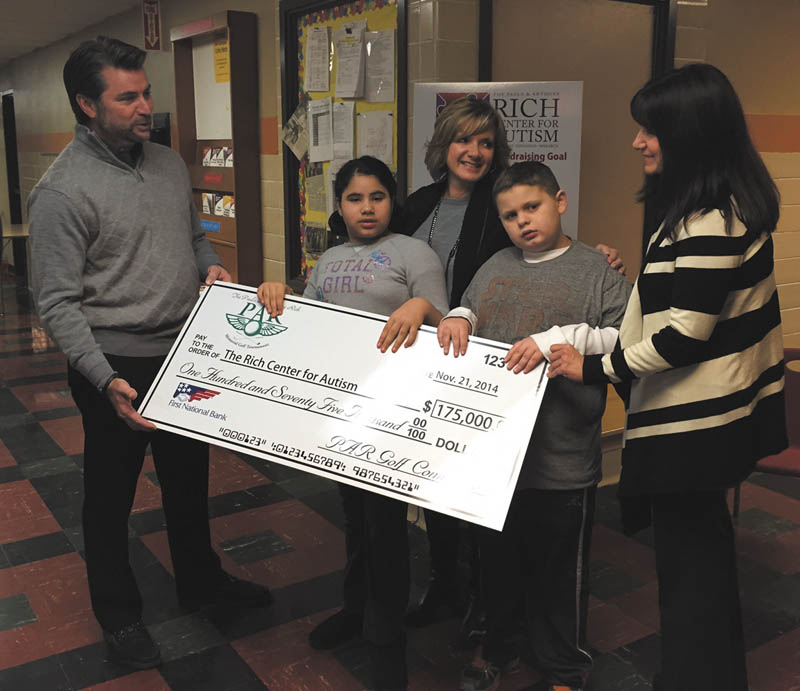 Special to The Vindicator: An oversized check displays the total of $175,000 raised at the Paula and Anthony Rich Memorial Golf Tournament on Sept. 5 and 8 at the Lake Club for the Rich Center for Autism. The event included dinner and an auction. From left are Dominic Marchionda, tournament co-chairman; Destiny Lopez, student at the Rich Center; Jacqueline Marchionda, tournament co-chairwoman; A.J. Wells, student; and Melanie Carfolo, executive director of the Rich Center. The center provides year-round therapy, education and support to 70 students at no cost to families. The Rich Center was established in 1995 by the Marchionda, Rubino, Ricchiuti and Kosar families. Fundraisers make the free services possible.  