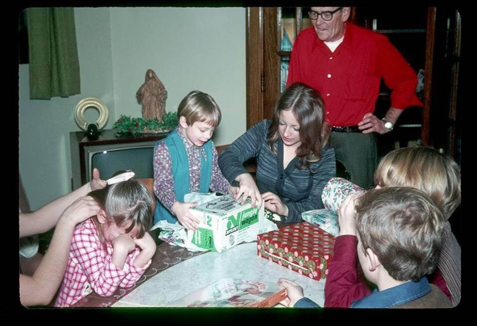 Family Christmas, about 1970. I'm crying because it isn't my turn to open gifts, but I love that everyone else is continuing on! Submitted by Janet Misel..