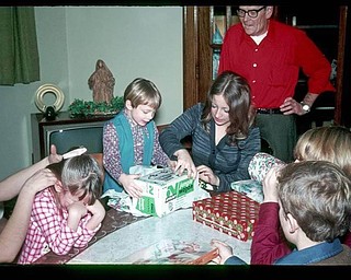 Family Christmas, about 1970. I'm crying because it isn't my turn to open gifts, but I love that everyone else is continuing on! Submitted by Janet Misel..