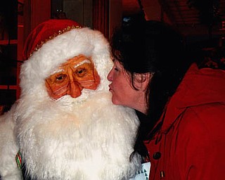 I saw auntie kissing Santa Claus! Doxie King kissed Santa at Fellows Riverside Gardens during its 2013 Winter Celebration. Sent by Doxie Damico of Austintown.