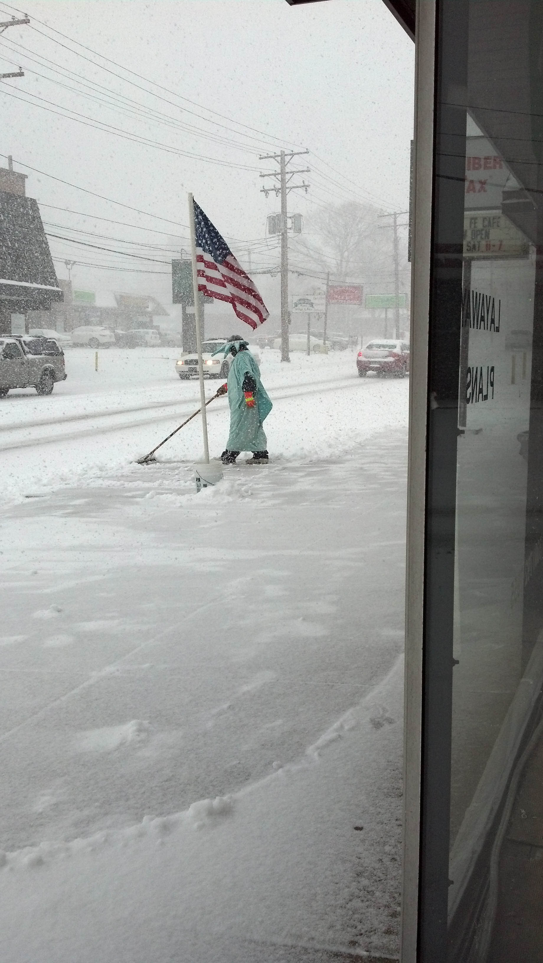 This photo was taken on Youngstown's West side near the Liberty Tax Center on Mahoning Avenue. I found poor Lady Liberty pushing snow amusing. Submitted by Ian J. Wade.