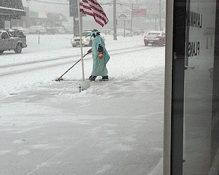 This photo was taken on Youngstown's West side near the Liberty Tax Center on Mahoning Avenue. I found poor Lady Liberty pushing snow amusing. Submitted by Ian J. Wade.
