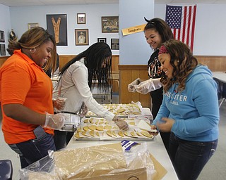        ROBERT K. YOSAY  | THE VINDICATOR..l-r around table starting at 9 pm-- Daisha Boyd- Gabrielle Boyd_ Madison hayes and Kierra Boyd..The Webster family again spent the Friday after Thanksgivng  at the Rescue Mission preparing food as their Patriarch and Matriarch of our family, Donald and Louise Webster (both deceased.) They were long time residents of Youngstown ..-30-