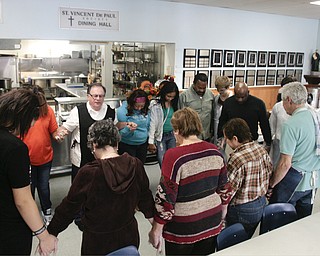        ROBERT K. YOSAY  | THE VINDICATOR..Fellowship and helping out.. as the ( webster clan)  grasps hands in a circle and prays before serving dinner at the Rescue Mission..The Webster family again spent the Friday after Thanksgivng  at the Rescue Mission preparing food as their Patriarch and Matriarch of our family, Donald and Louise Webster (both deceased.) They were long time residents of Youngstown ..-30-