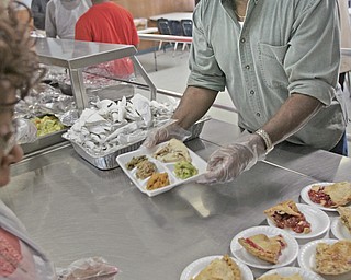        ROBERT K. YOSAY  | THE VINDICATOR..Mark Boyd gets a plate ready for distribution..The Webster family again spent the Friday after Thanksgivng  at the Rescue Mission preparing food as their Patriarch and Matriarch of our family, Donald and Louise Webster (both deceased.) They were long time residents of Youngstown ..-30-