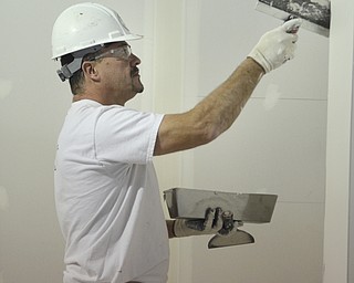 Katie Rickman | The Vindicator.John Dillon of North Jackson works on dry wall in one of the classrooms at the Warren Center which is an extension of Eastern Gateway Community on Tuesday, Dec. 2, 2014. The new center will open in January 2015.