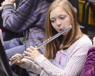 Katie Rickman | The Vindicator.Abigale Peterson 12 of Struthers Middle School plays the flute as she and other students practice for an upcoming performance Dec. 2, 2014.  Peterson is one of many who joined the extracurricular band that will be performing Thursday, December 4, 2014.