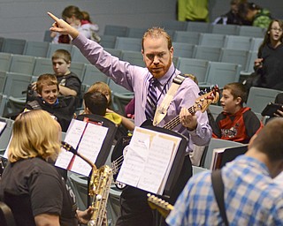 Katie Rickman | The Vindicator.Josh Hawkins, band director at Struthers Middle School, directs the jazz band during practice Tuesday, Dec. 2, 2014 in the auditorium at the school. The jazz band will have a concert Thursday, Dec. 4th at 6:30 pm..