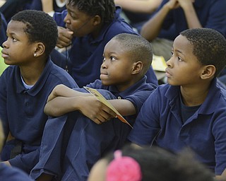 Katie Rickman | The Vindicator.Stambaugh Charter Academy 5th graders (L-R) Lavell Young, Demarion Langston, and Chris Cunningham listen to former NBA Pheonix Sun player Michael Morrison speak during a special assembly on Tuesday, Dec. 2, 2014.