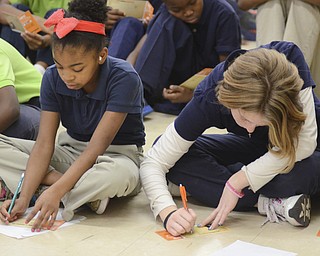 Katie Rickman | The Vindicator.Teonie Jones, on left, and Kailey May, both 5th graders at Stambaugh Charter Academy write on pledge forms after former NBA Phoenix Sun basketball player Michael Morrison spoke at the school on Tuesday, Dec. 2, 2014.