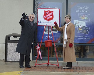 Katie Rickman | The Vindicator.Jim Tressel waves along side his wife Ellen as cars pass Barnes and Noble in Boardman where the Tressel's volunteered to work for The Salvation Army on Tuesday, Dec. 2, 2014.