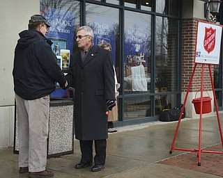 Katie Rickman | The Vindicator.Walter M. Duzzny Sr. of Youngstown shakes hands with Jim Tressel outside of Barnes and Noble in Boardman where Tressel and his wife Ellen volunteered with The Salvation Army on Tuesday, Dec. 2, 2014.