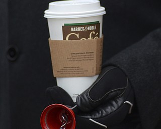 Katie Rickman | The Vindicator.Jim Tressel holds a coffee cup and the red bell from The Salvation Army outside of Barnes and Noble where he and his wife Ellen volunteered to raise money for on Tuesday, Dec. 2, 2014.