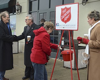 Katie Rickman | The Vindicator.Mark Haney who is visiting from florida shakes hands with Jim Tressel as Marian Kutlesa of Struthers donates money to The Salvation Army, Ellen Tressel stands to the right and wishes Kutlesa a happy holiday on Tuesday, Dec. 2, 2014.