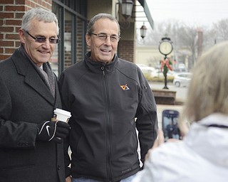 Katie Rickman | The Vindicator.JoAnn Scott of Boardman snaps a cellphone photo of her husban Bill, on right, with Jim Tressel outside of Barnes and Noble in Boardman where Jim and Ellen Tressel volunteered to raise money for The Red Cross on Tuesday, Dec. 2, 2014.
