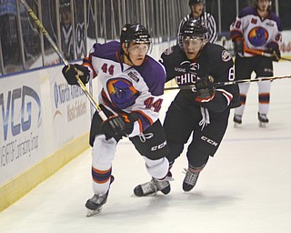 Katie Rickman | The Vindicator.Phantoms Kiefer Sherwood (44) skates up the ice as Chicago Steel's Peter Tischke (6) tries to block him during the first period at the Covelli Centre on Dec. 3, 2014.