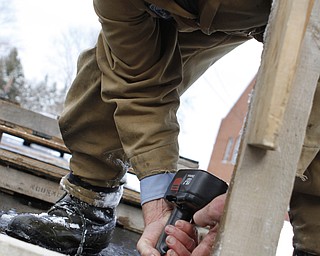 Henry Schell of New Castle, Pa screws together the base of a set during the drive through nativity set at the Kings Chapel United Methodist Church in New Castle, Pa on Friday morning.  Dustin Livesay  |  The Vindicator    11/28/14  New Castle Pa