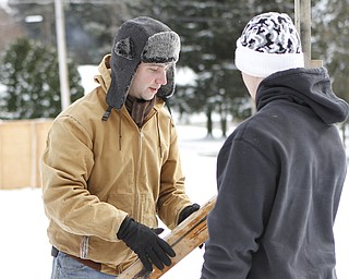 Jim Weltman of New Castle positions wood to be screwed into place during the drive through nativity set at the Kings Chapel United Methodist Church in New Castle, Pa on Friday morning.  Dustin Livesay  |  The Vindicator    11/28/14  New Castle Pa