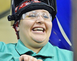 Jeff Lange | The Vindicator  Esther Thomas of Struthers smiles as she shares a moment with her instructor during Monday afternoon's welding class at MCCTC in Canfield.
