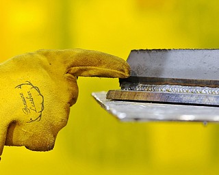 Jeff Lange | The Vindicator  Morgan Cook of Canfield points out what a good bead looks like when welding during Monday afternoon's welding class at MCCTC in Canfield.