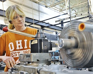 Jeff Lange | The Vindicator  Lisbon resident Kathleen Clarke operates an automatic turning lathe during Monday afternoon's machining class at MCCTC in Canfield.