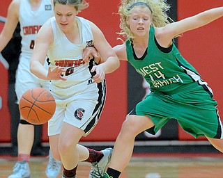 Jeff Lange | The Vindicator  West Branch's Melinda Trimmer (14) shoves Canfield's Lynne Whitehead as she dribbles the ball up court during the first period of Wednesday night's girls basketball game in Canfield.