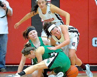Jeff Lange | The Vindicator  Canfield's Ashley Kaleel (right) fights for the ball with two West Branch players Emily Menegay (front) and Paige Walsh (back) while Canfield's Emily Ellis looks on from behind in the first half of Wednesday night's contest in Canfield.