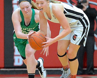 Jeff Lange | The Vindicator  West Branch's Catie Hahn (left) looks to steal the ball away from Canfield's Erin Risner as she dribbles the ball down the court during first half action of their matchup, Wednesday evening in Canfield.