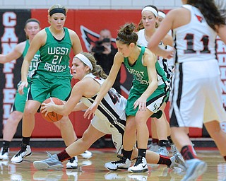 Jeff Lange | The Vindicator  Canfield's Savannah Barko (with ball) slips past West Branch's Pavin Heath (21) and Emily Menegay (right) in the second half of their matchup, Wednesday evening in Canfield.