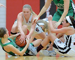 Jeff Lange | The Vindicator  Canfield's Erin Risner (facing) strips the ball away from West Branch's Emily Menegay (left) as Canfield's Ashley Kaleel (right) looks on during second half action Wednesday night in Canfield.