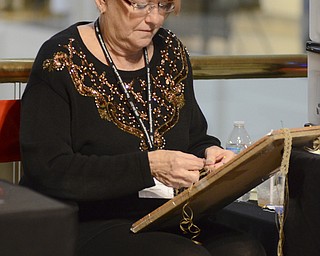 Diana Lynn Craig of Hubbard works on a micro macrame bracelet at her Bead Artistry display during the 44th Annual American Holiday Arts & Crafts Show and Sale at The Butler Institute of American Art on Saturday, Dec. 6, 2014.